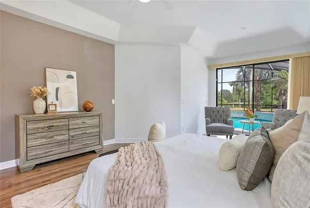 a bedroom with a bed and large windows