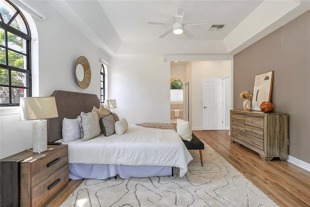 13124 Filly Court Windermere, FL 34786 - Photo 19 of 50 a bedroom with a bed and dresser with mirror