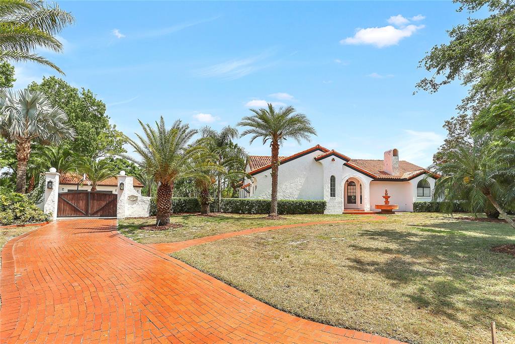 13124 Filly Court Windermere, FL 34786 - Photo 2 of 50 a front view of a house with a yard and palm trees