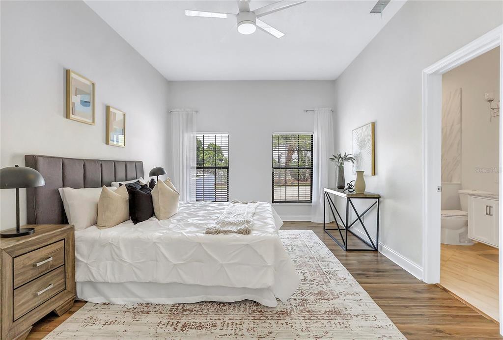 13124 Filly Court Windermere, FL 34786 - Photo 27 of 50 a large bedroom with a bed and wooden floor