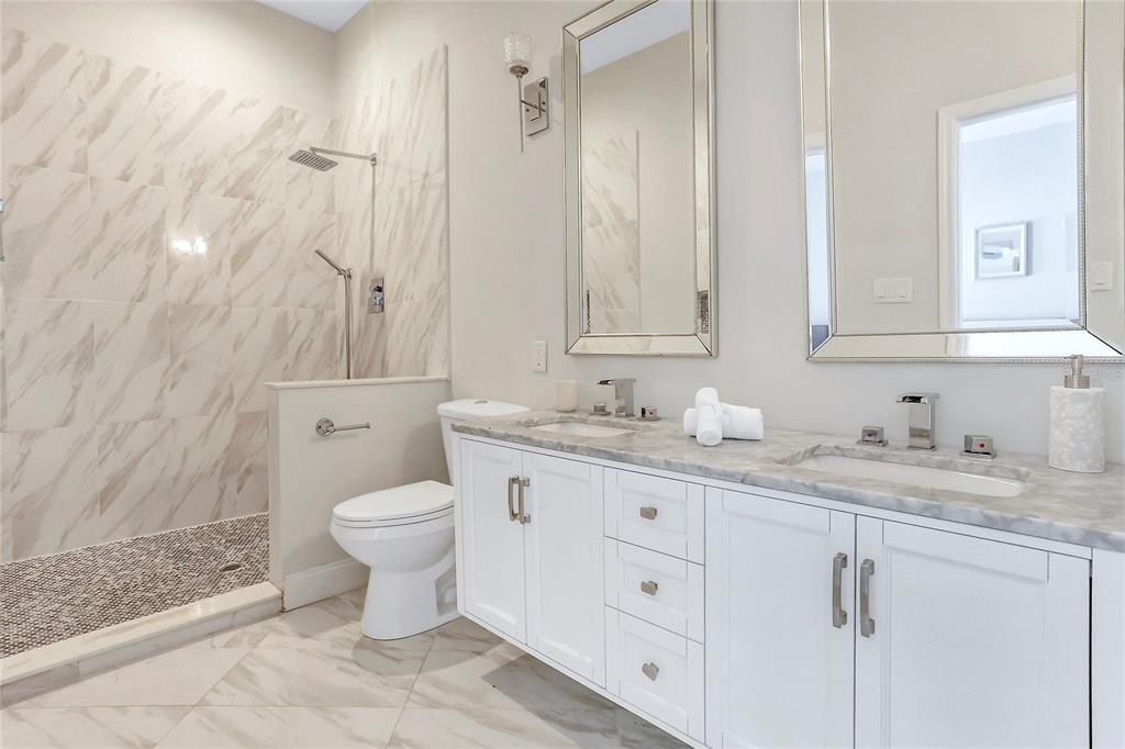 13124 Filly Court Windermere, FL 34786 - Photo 28 of 50 a bathroom with a granite countertop toilet sink and mirror