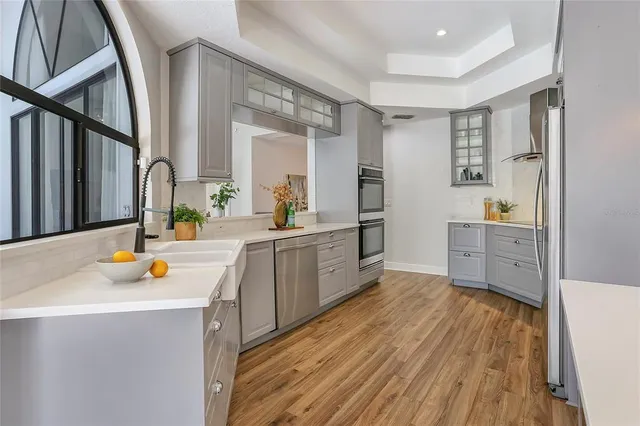 a kitchen with wooden floors and sink