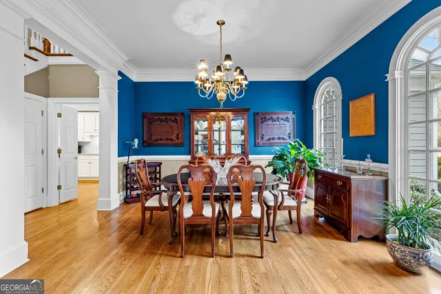 a view of a dining room with furniture and a large window