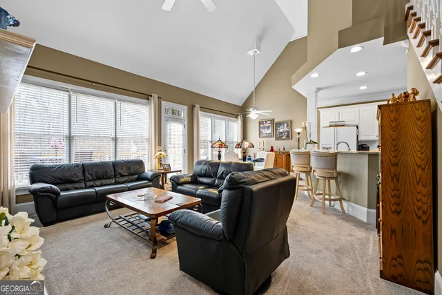 a living room with furniture and a dining table