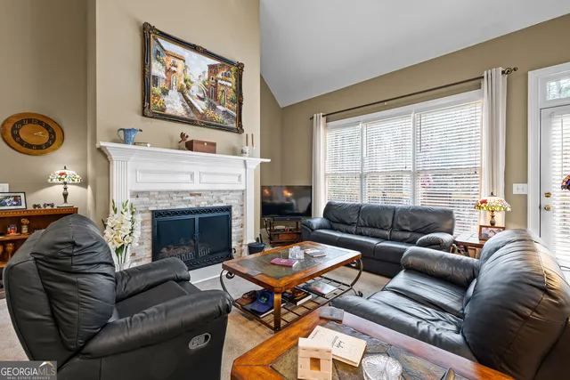 a living room with furniture and a book shelf