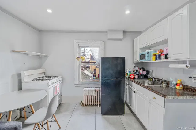 a kitchen with a refrigerator and window