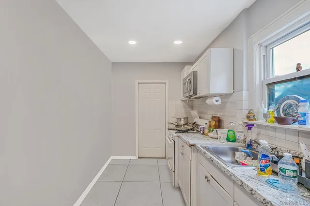 a kitchen with a sink a stove and cabinets