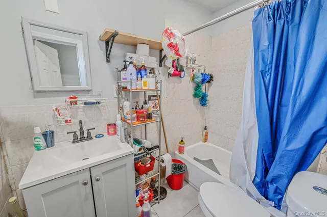 a bathroom with a sink toilet vanity and window