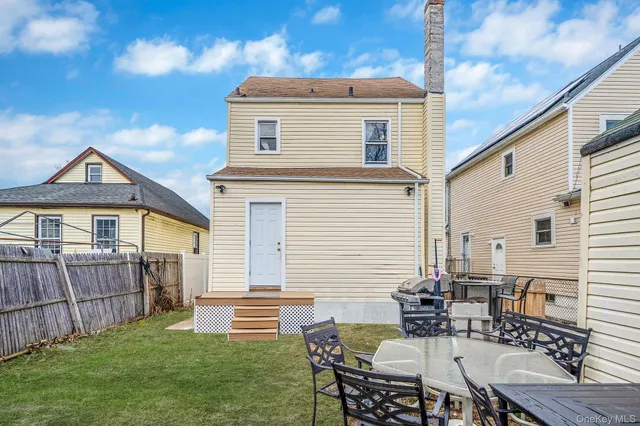 a view of backyard of house with seating space