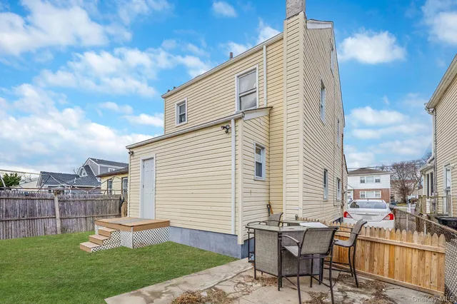 a backyard of a house with table and chairs