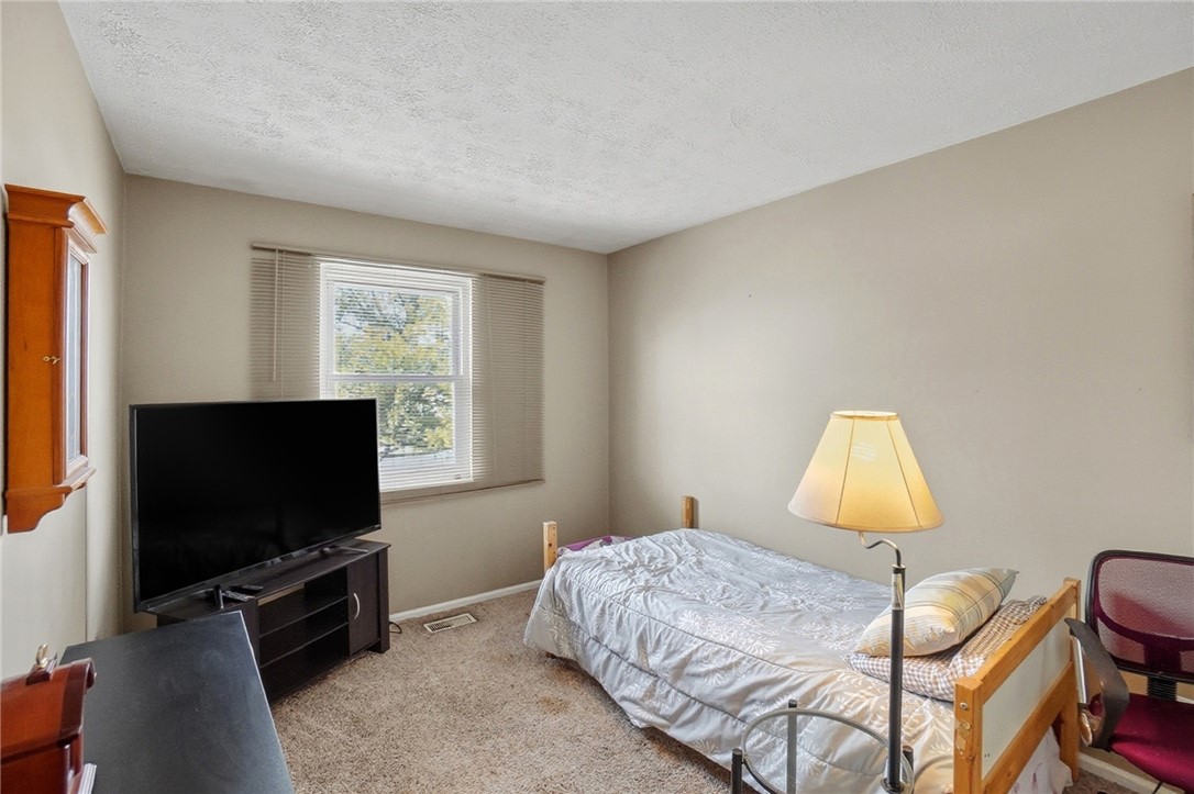 4780 Old Salem Road Englewood, OH 45322 - Photo 15 of 30 This cozy bedroom features comfortable flooring and a bright window.