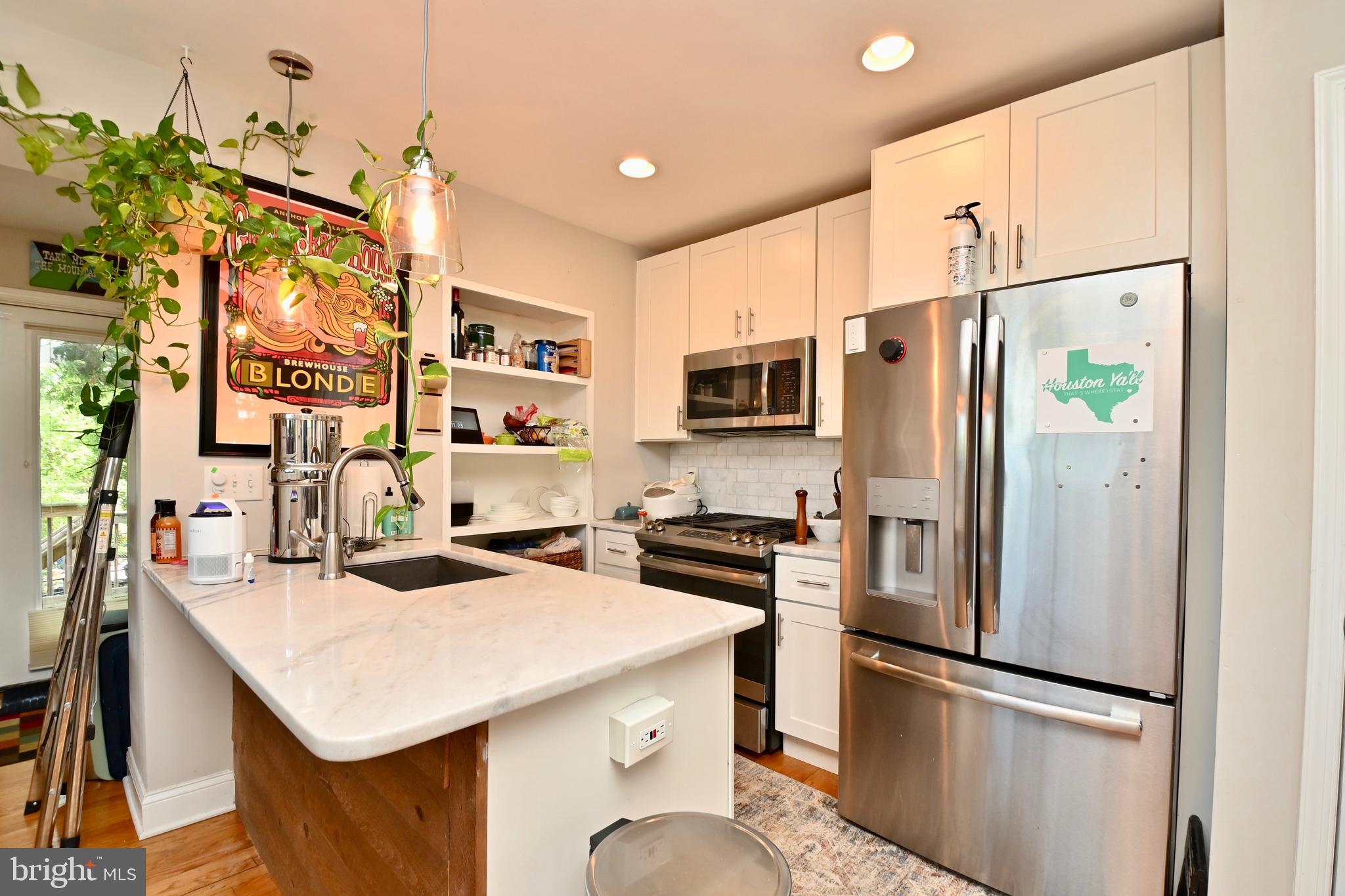 14 53rd Street Southeast Washington, DC 20019 - Photo 23 of 46 a kitchen with stainless steel appliances a stove refrigerator sink and microwave