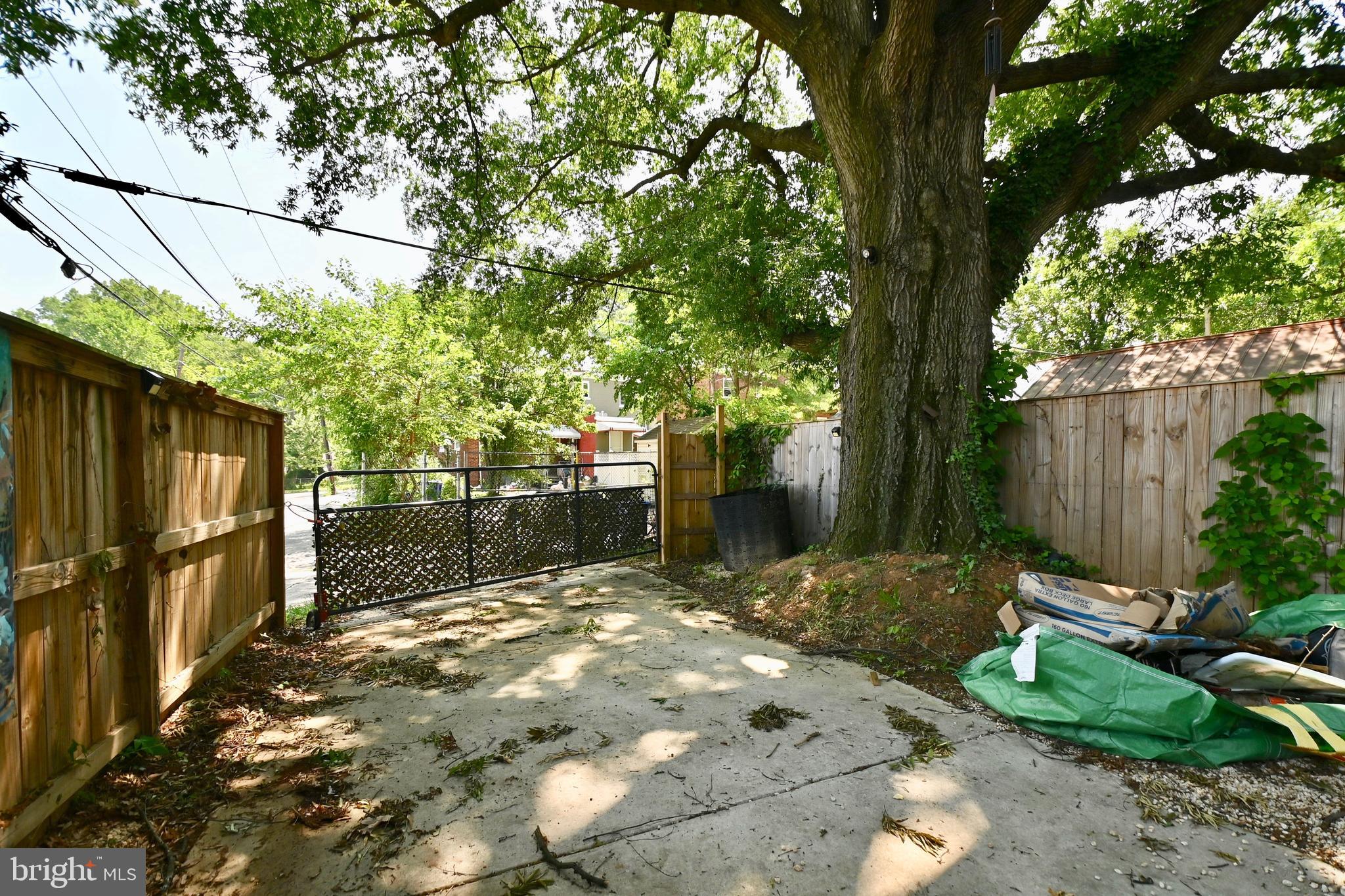 14 53rd Street Southeast Washington, DC 20019 - Photo 31 of 46 a view of a backyard with wooden fence and large tree