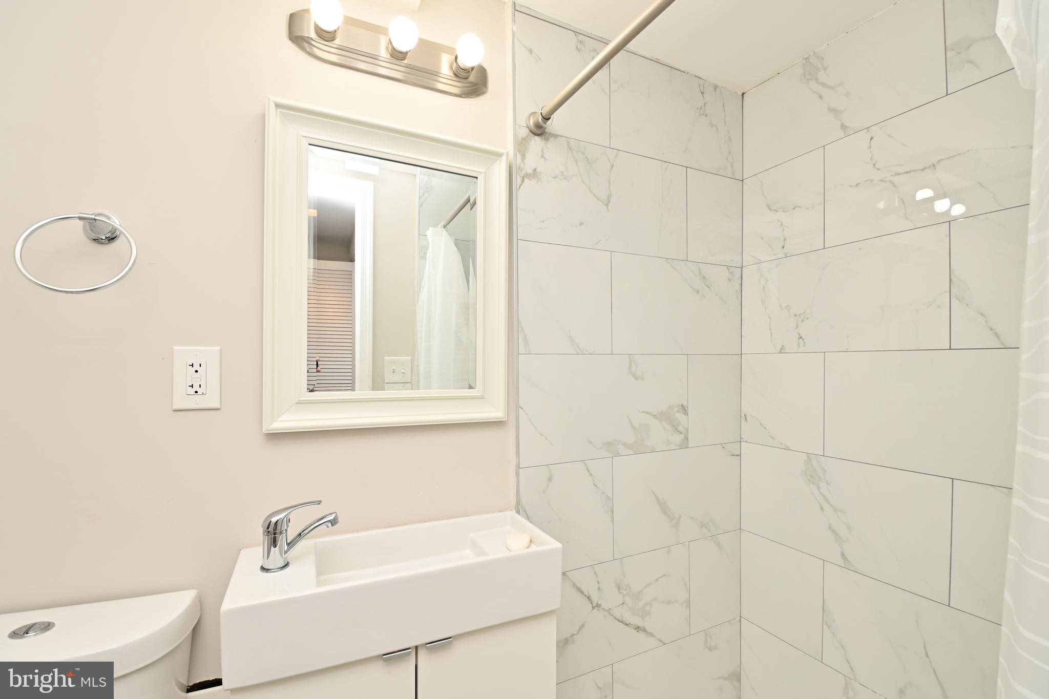 14 53rd Street Southeast Washington, DC 20019 - Photo 33 of 46 a bathroom with a sink a toilet and shower