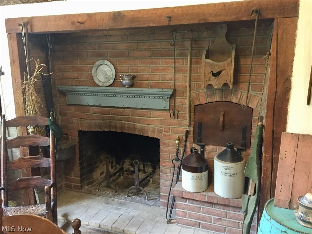 2386 Ridgewood Road Medina, OH 44256 - Photo 21 of 35 I thought you might like a closer view of the fireplace in the dining/hearth room. Behind the wooden door is access to the original brick oven. Today it is used for storage of wood. On a cooler day, this fireplace would have a warm and inviting fire burning.