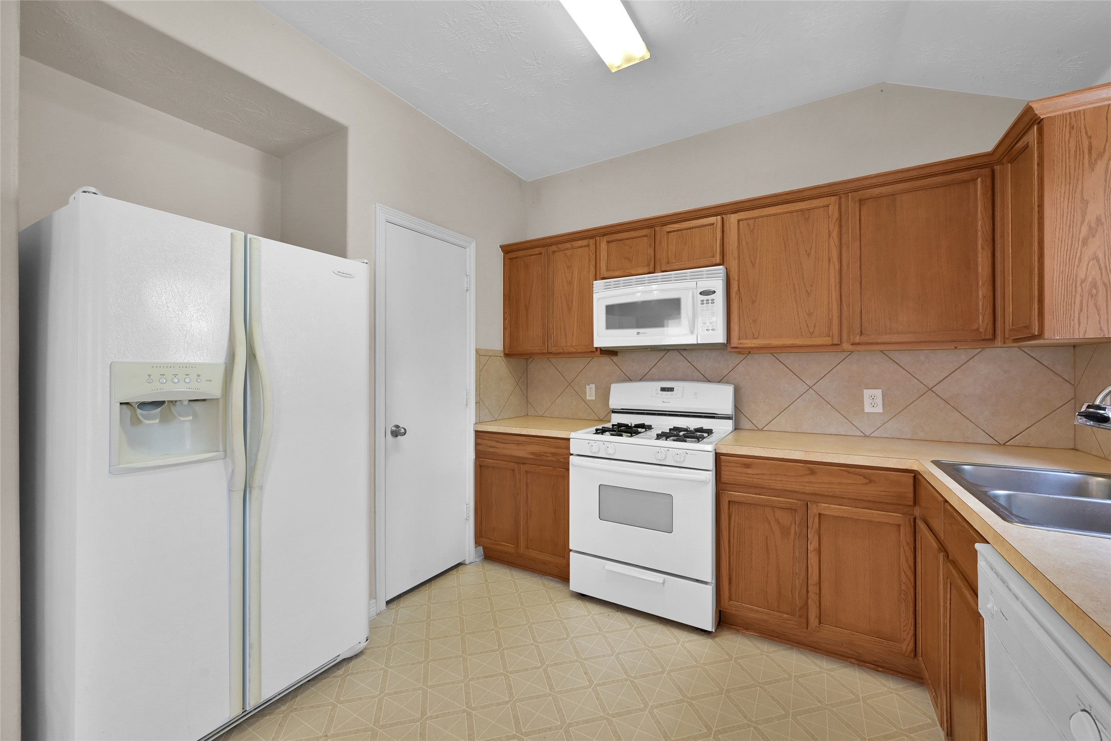 5046 Willow Point Drive Conroe, TX 77303 - Photo 13 of 44 a kitchen with stainless steel appliances granite countertop a refrigerator sink and stove