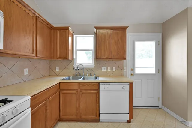 a kitchen with a sink cabinets and window