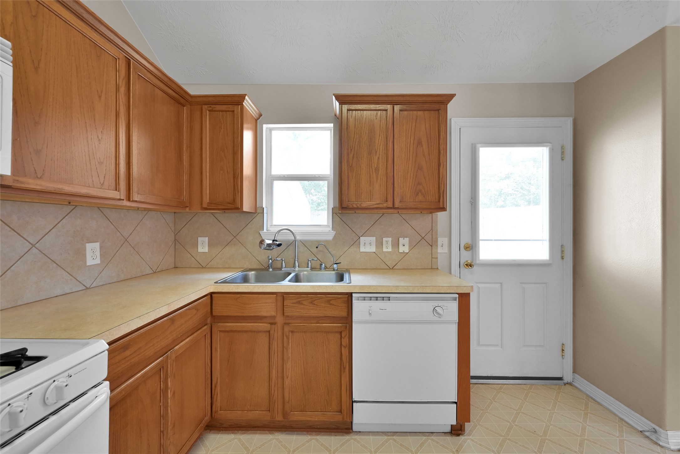 5046 Willow Point Drive Conroe, TX 77303 - Photo 14 of 44 a kitchen with a sink cabinets and window