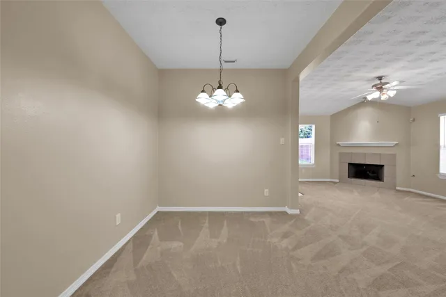 a view of a room with a fireplace and chandelier