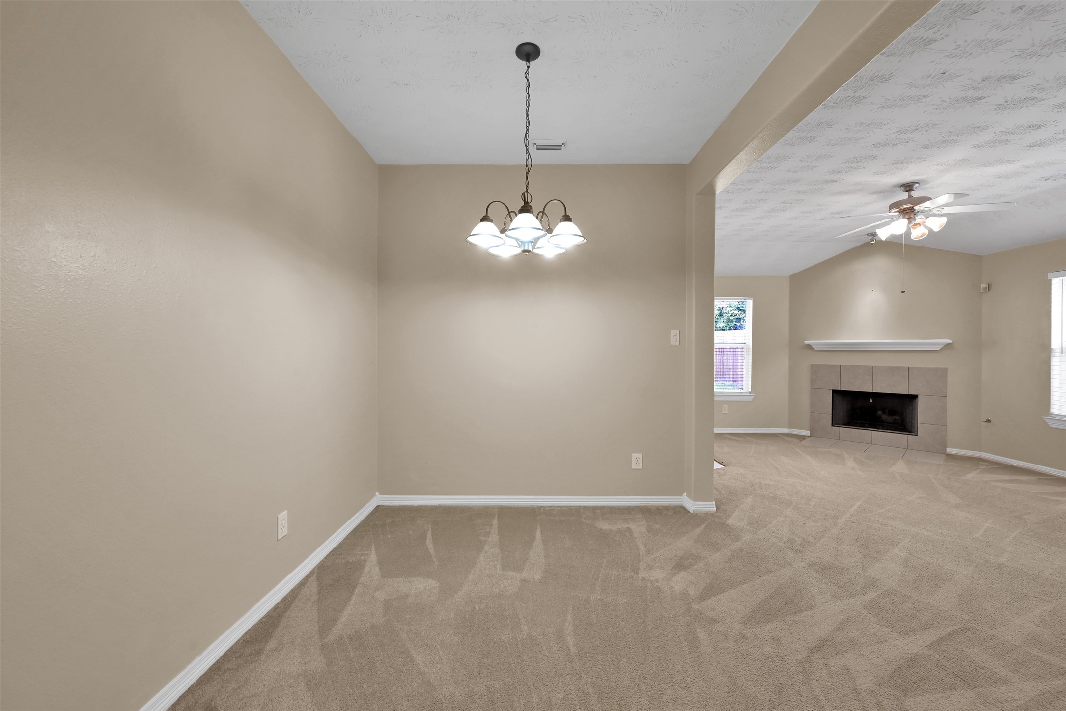 5046 Willow Point Drive Conroe, TX 77303 - Photo 18 of 44 a view of a room with a fireplace and chandelier