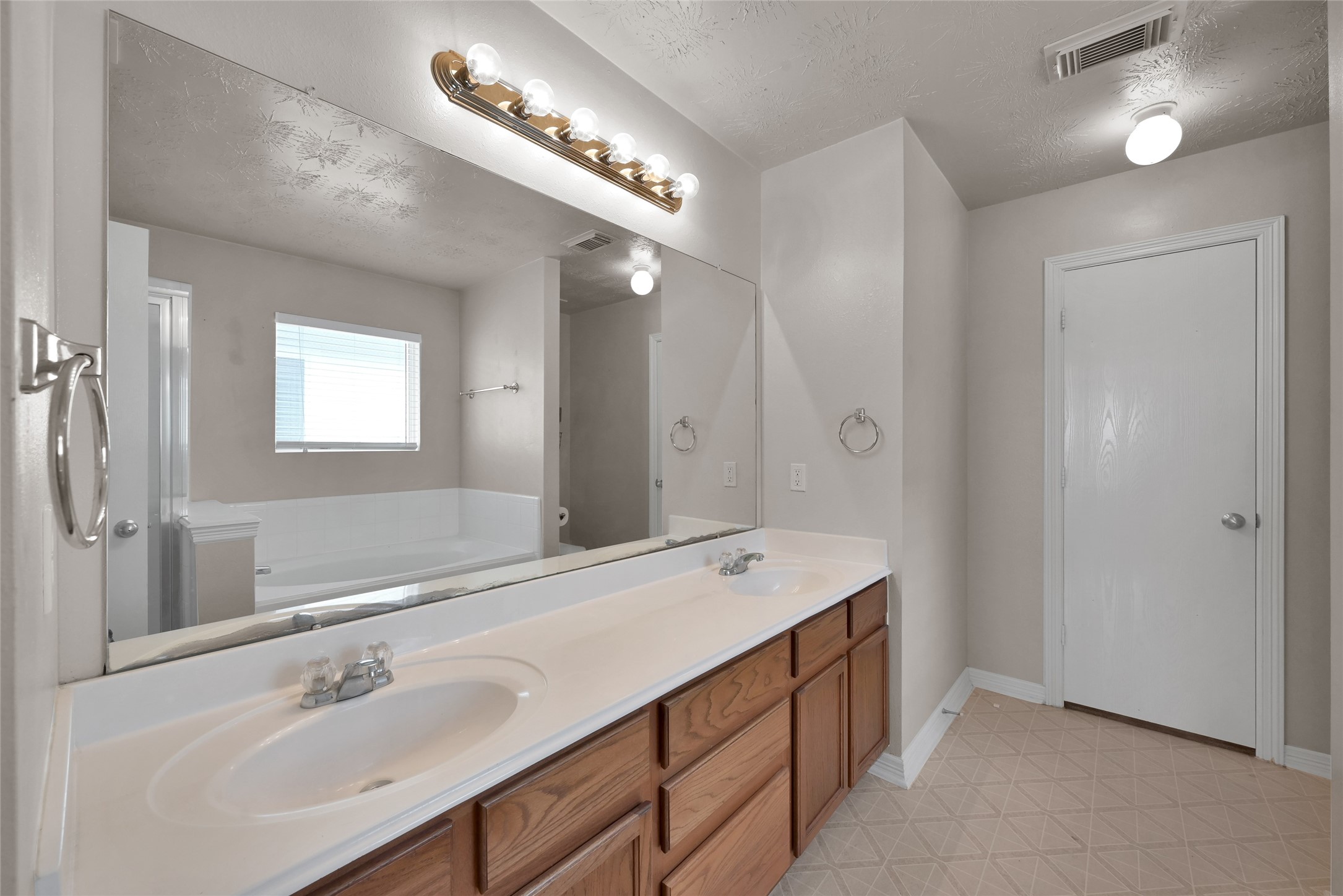5046 Willow Point Drive Conroe, TX 77303 - Photo 24 of 44 a bathroom with a sink double vanity and a mirror
