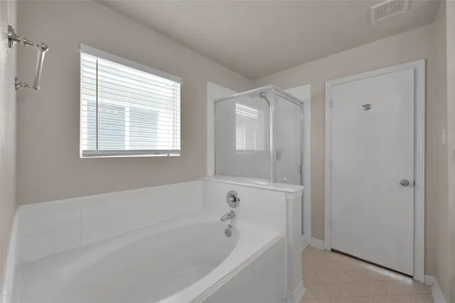 a white bath tub sitting next to a window