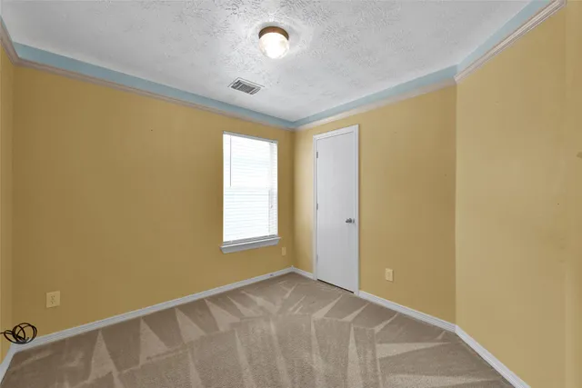 a view of an empty room and a window