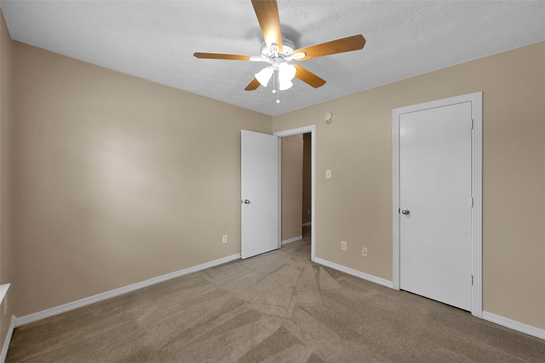 5046 Willow Point Drive Conroe, TX 77303 - Photo 33 of 44 an empty room with a chandelier fan and windows