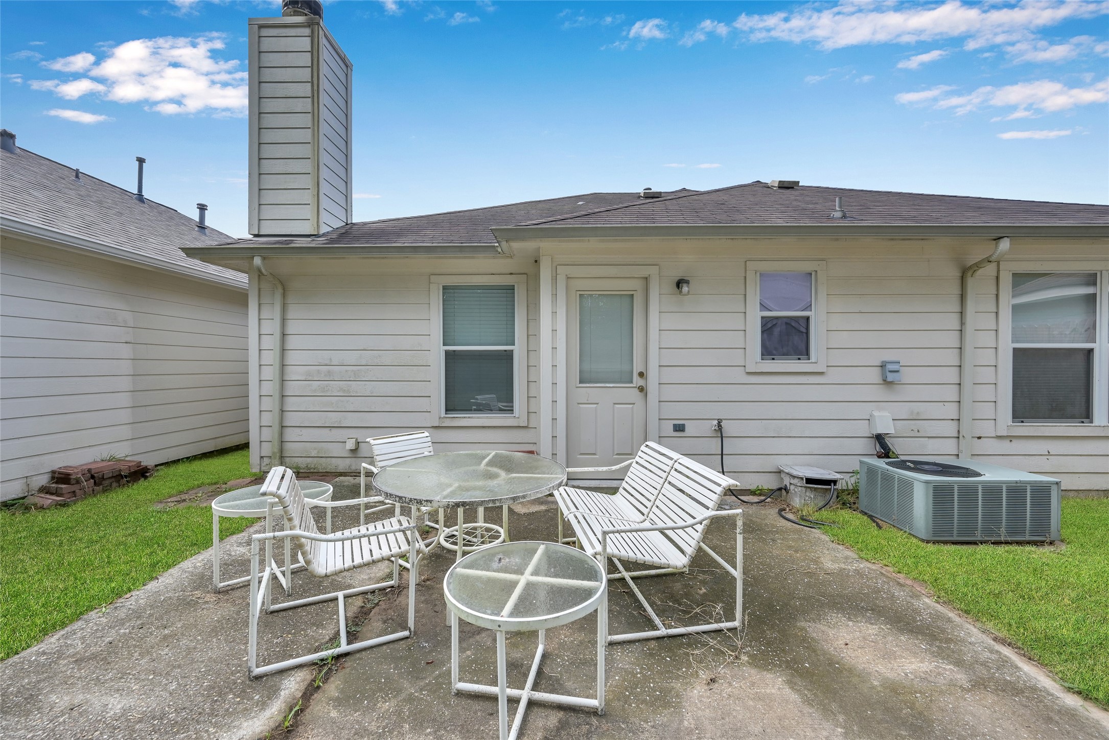 5046 Willow Point Drive Conroe, TX 77303 - Photo 37 of 44 a view of a chair and table in backyard of the house