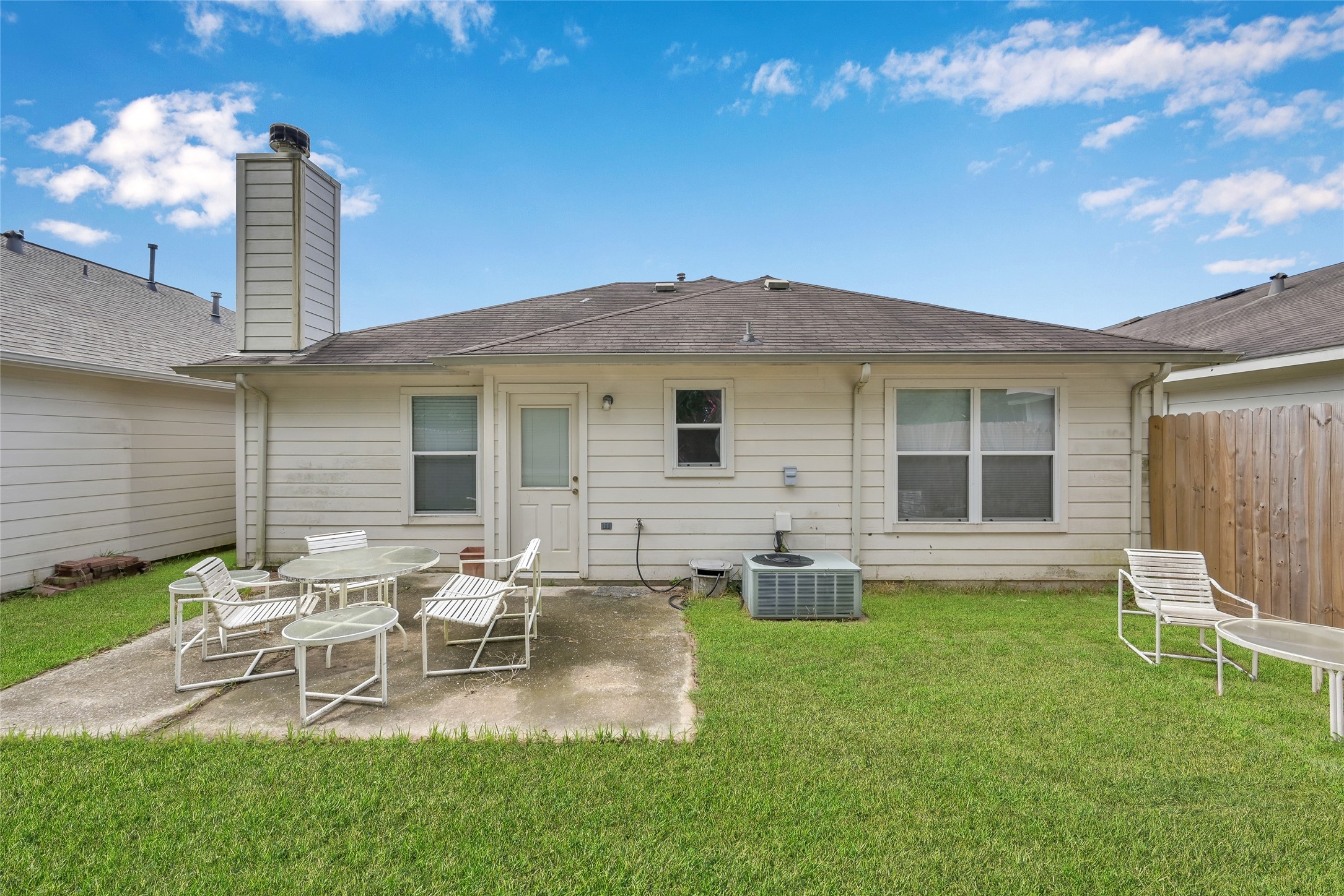 5046 Willow Point Drive Conroe, TX 77303 - Photo 39 of 44 a view of a house with a backyard and chairs
