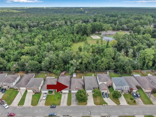 an aerial view of a house with a yard