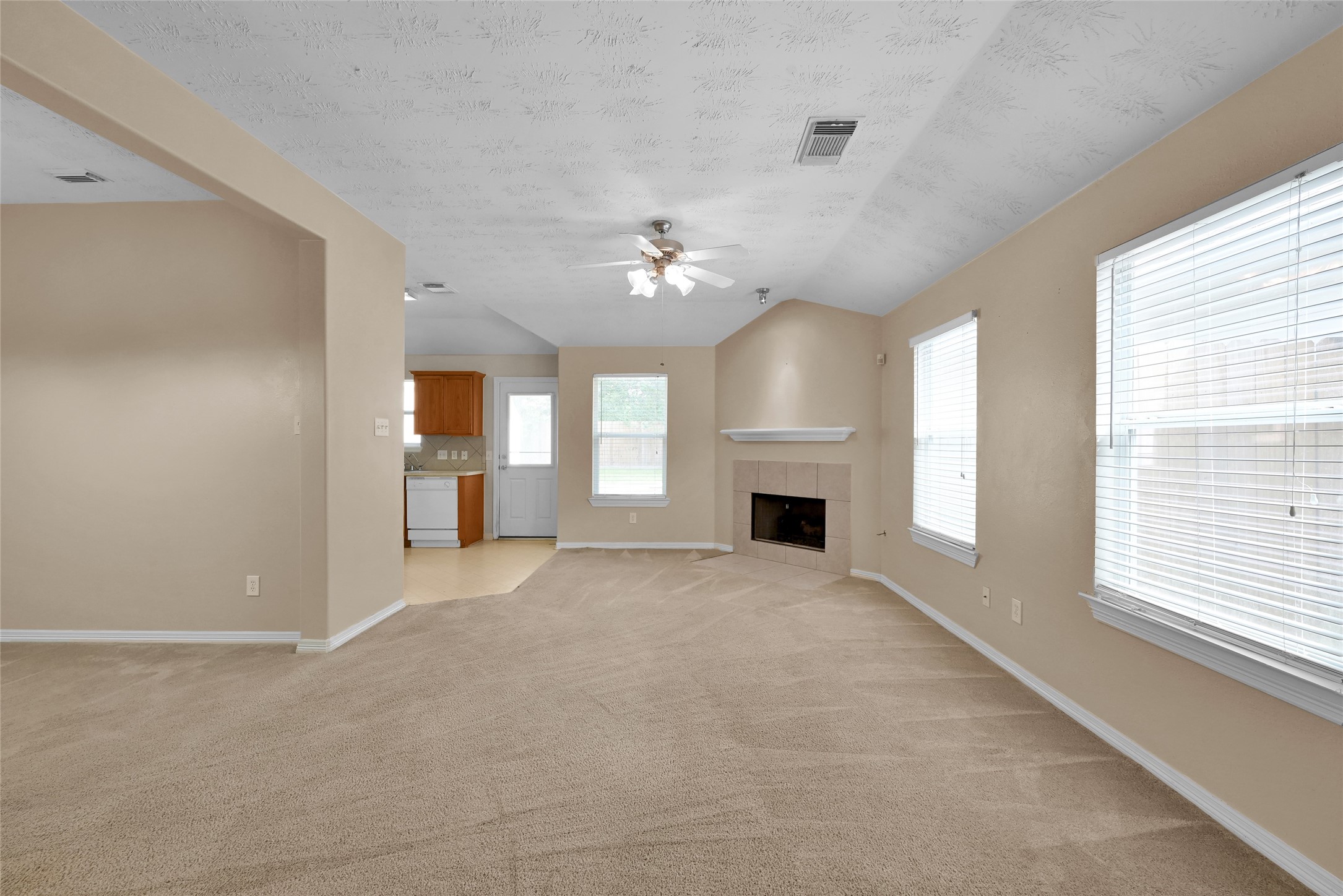5046 Willow Point Drive Conroe, TX 77303 - Photo 7 of 44 a view of an empty room with a fireplace and a window