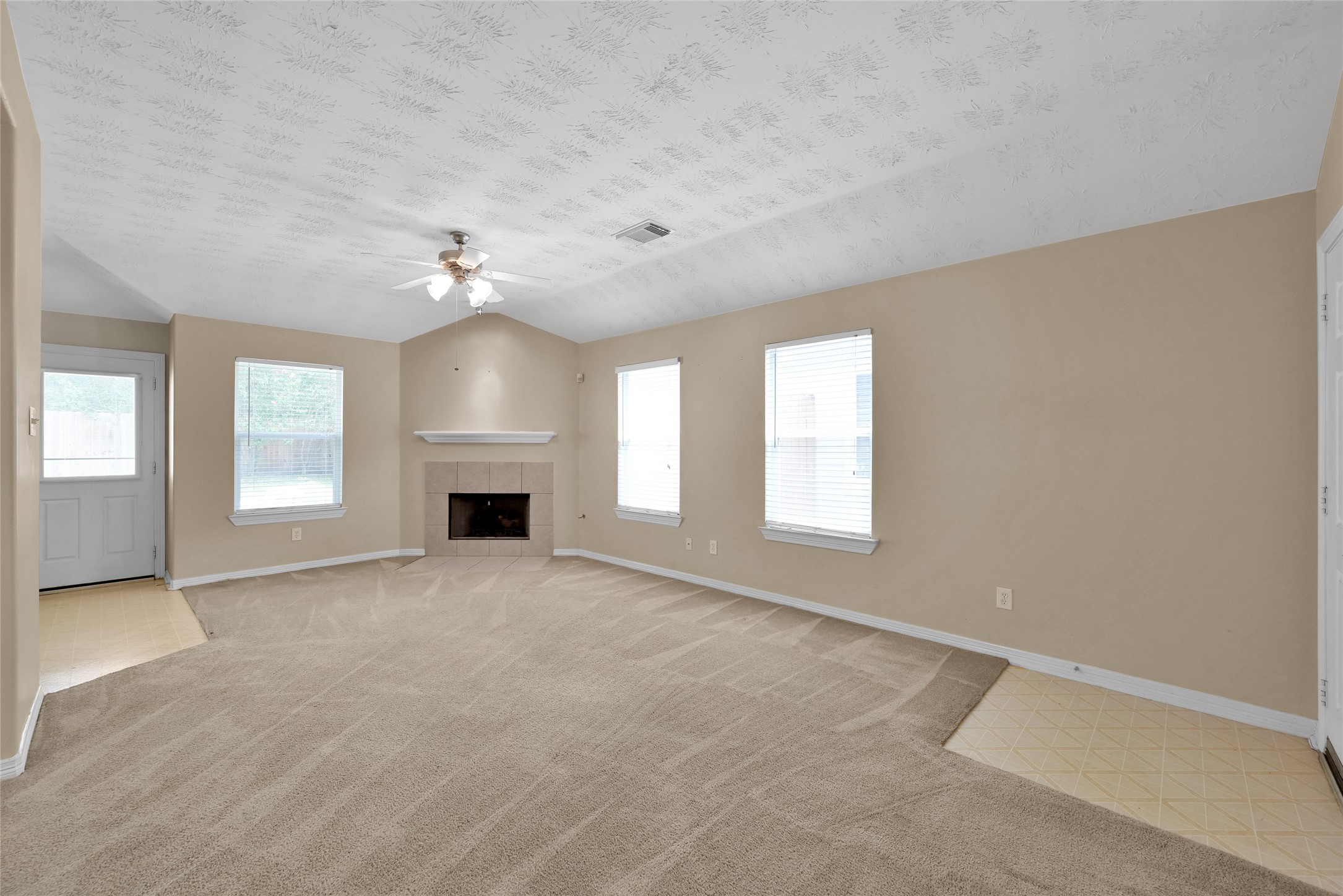 5046 Willow Point Drive Conroe, TX 77303 - Photo 8 of 44 an empty room with windows and fireplace