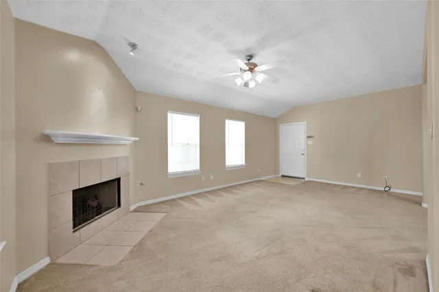 a view of empty room with a fireplace