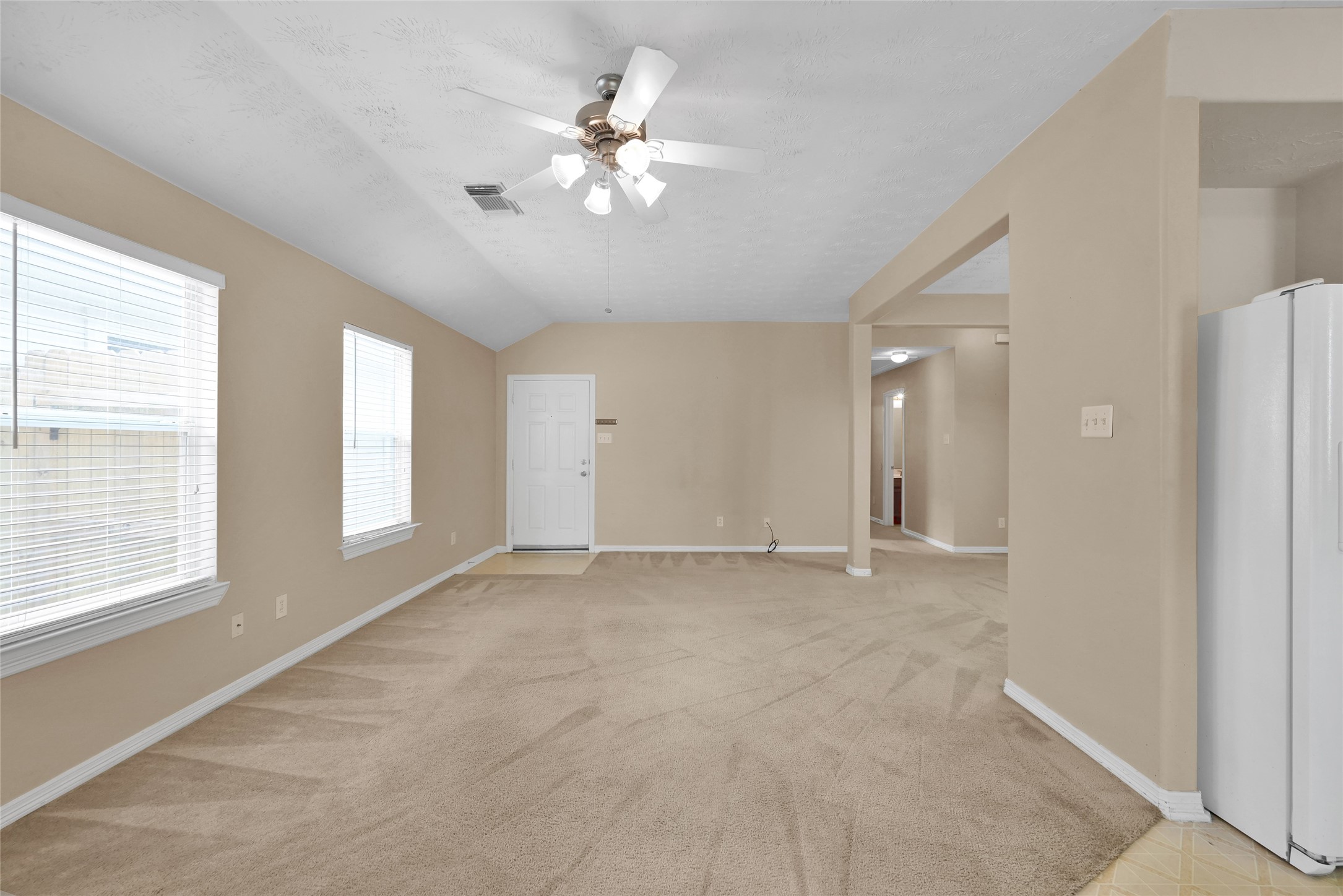 5046 Willow Point Drive Conroe, TX 77303 - Photo 10 of 44 an empty room with chandelier fan and windows