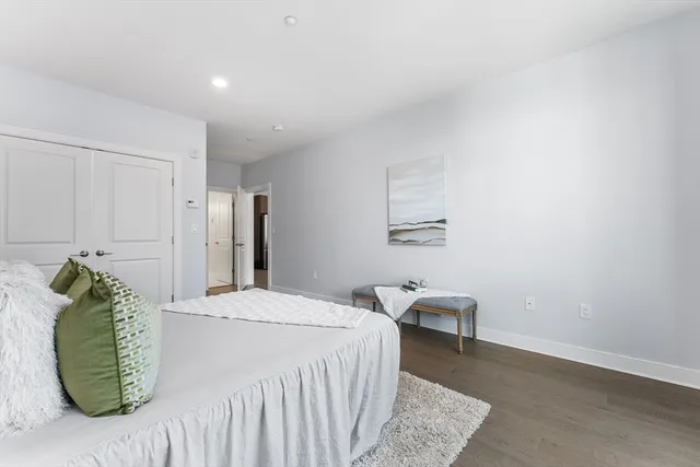 a bedroom with a bed and a chair