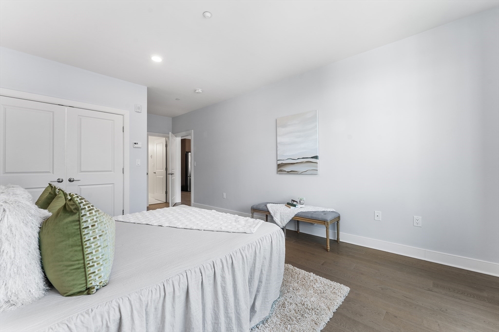 2 Cliveden Street, Unit 405E Quincy, MA 02169 - Photo 11 of 18 a bedroom with a bed and a chair