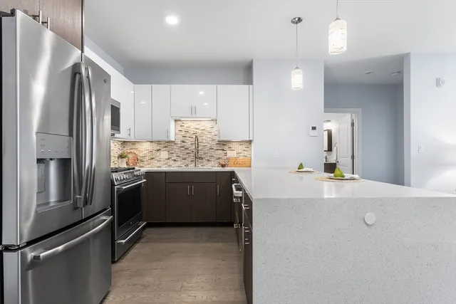 a kitchen with stainless steel appliances a refrigerator sink and stove
