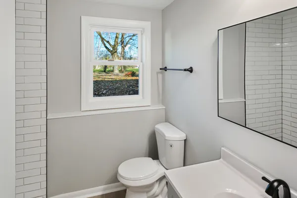 a white toilet sitting next to a bathroom sink