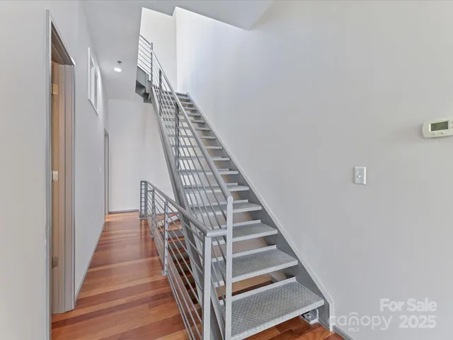 a view of hallway with wooden floor