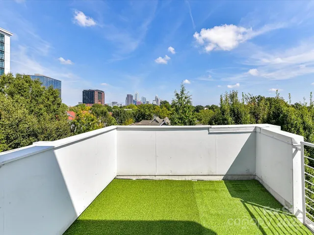 an aerial view of house with yard and trees in the background
