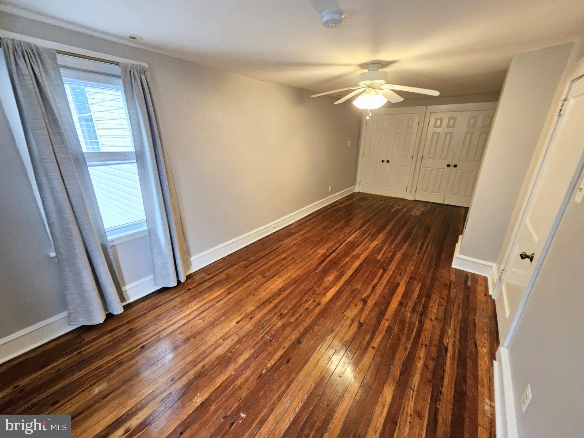 6 Arthur Road, Unit FRONT Rosemont, PA 19010 - Photo 12 of 24 Spacious room with gleaming hardwood floors.