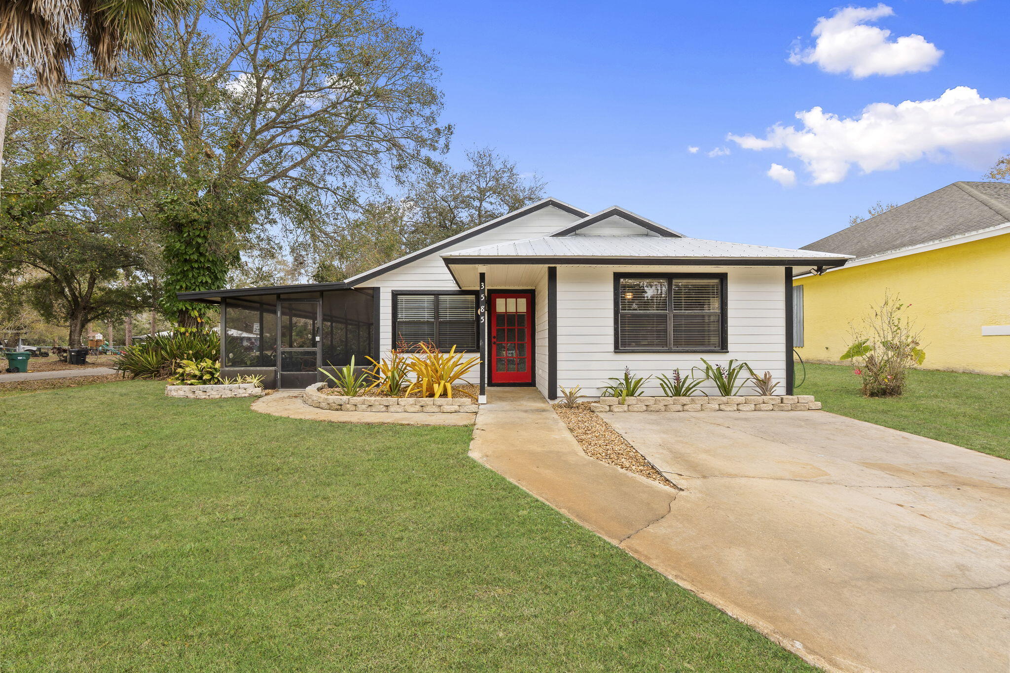 3585 Southeast 8th Street Okeechobee, FL 34974 - Photo 1 of 39 a front view of a house with garden and porch