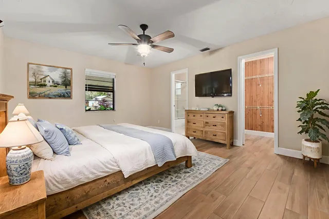 a bedroom with a bed and a flat screen tv