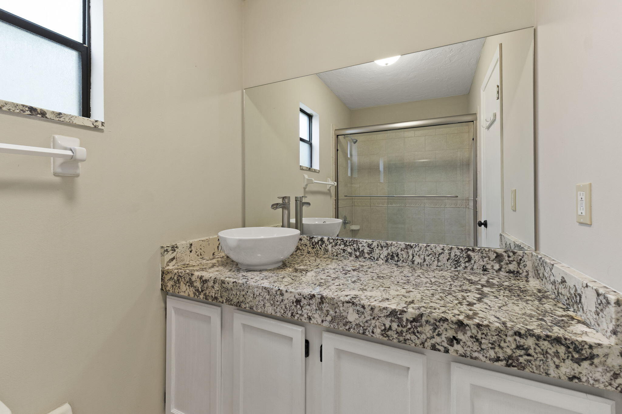 3585 Southeast 8th Street Okeechobee, FL 34974 - Photo 20 of 39 a bathroom with a granite countertop sink and a mirror