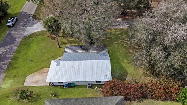 an aerial view of a house with a yard