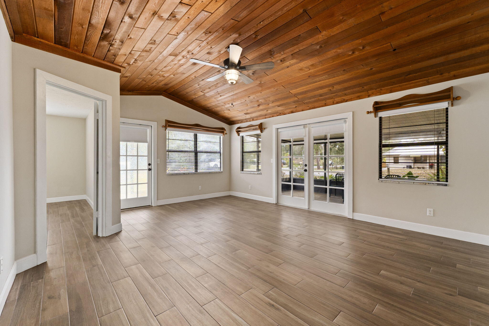 3585 Southeast 8th Street Okeechobee, FL 34974 - Photo 9 of 39 a view of an empty room with a window and wooden floor