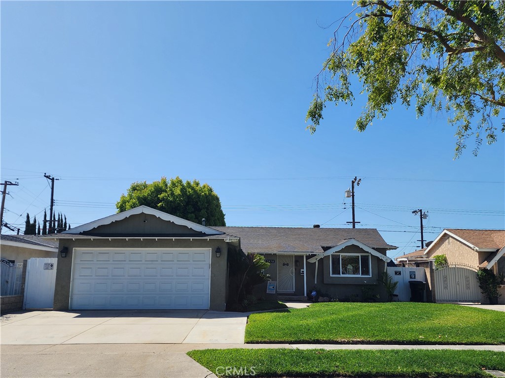 7450 Thunderbird Lane Stanton, CA 90680 - Photo 1 of 31 a front view of a house with a garden and plants