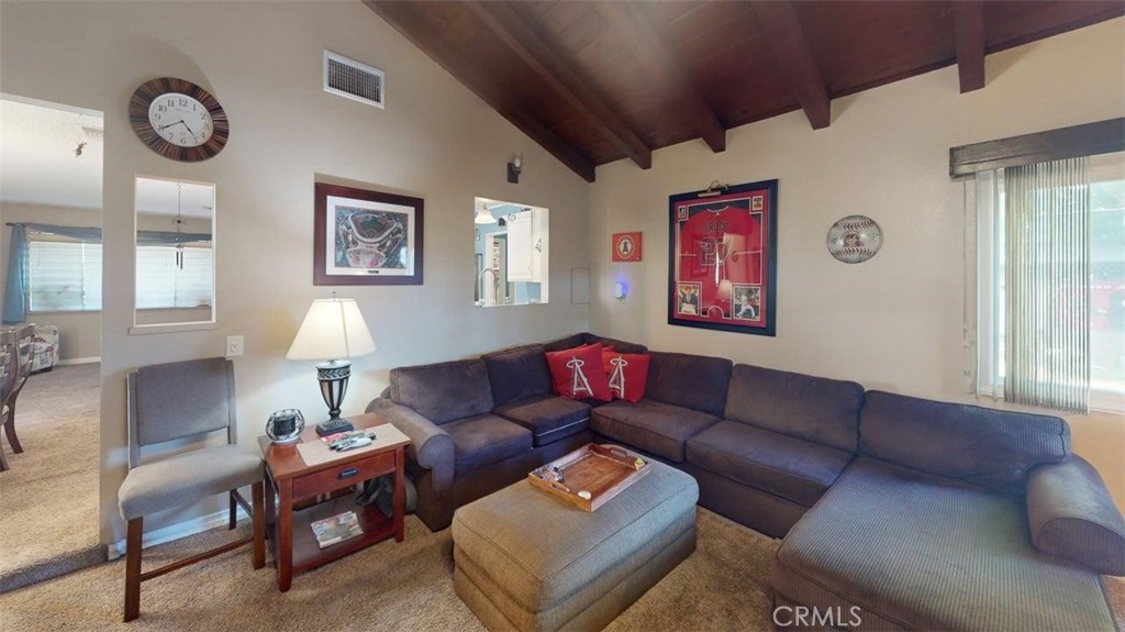 7450 Thunderbird Lane Stanton, CA 90680 - Photo 11 of 31 a living room with furniture a large window and a lamp
