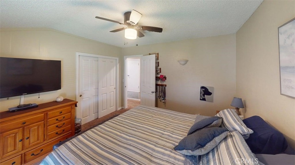 7450 Thunderbird Lane Stanton, CA 90680 - Photo 14 of 31 a bedroom with a bed and a flat screen tv